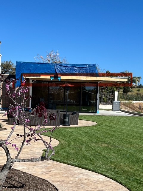 New lawn and pathways beside a structure under construction