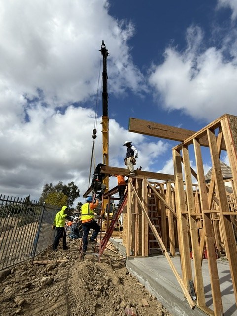 Crane lifting framing into place