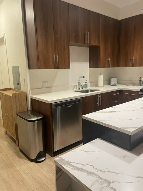 Kitchen with walnut cabinets and marble-look counters